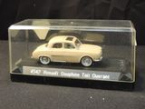 a small toy car in a clear box on a table