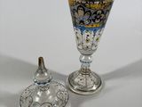 two glass goblets sitting next to each other on a table