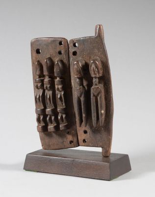 a close up of a sculpture of two people on a wooden base