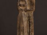 a statue of two people standing next to each other on a table