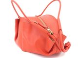 an image of an orange purse with a zipper on it