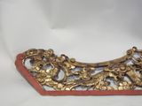 an image of a gold and red decorative piece on a white background