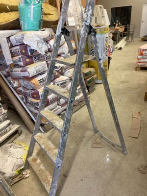 a ladder that is sitting in the middle of a room