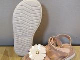 baby girl ' s sandals with a flower on the sole