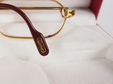 a pair of glasses sitting in a box on a bed