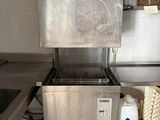 a large stainless steel pot on a stand in a kitchen