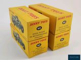 three boxes of dinky toys are stacked on top of each other