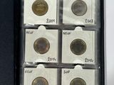 several quarters of coins are in a black box on a white surface
