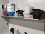 a small kitchen with a sink and a lot of dishes on the shelves