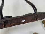 a wooden door handle with brass knobs on it