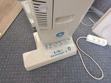 a small air conditioner sitting on the floor next to a wall