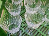six empty wine glasses sitting on a green tray