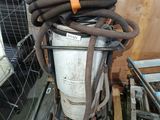 an image of a pile of hoses sitting on top of a metal container