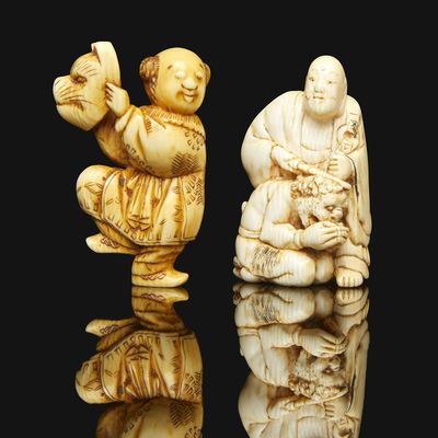 two carved ivory figurines of a man and a woman