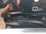 someone is taking a picture of the dashboard of a car with their cell phone