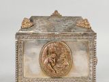 an image of a silver box with a picture of a man and a woman on it