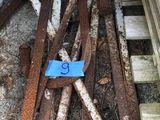 a pile of rusted metal on the ground next to a building