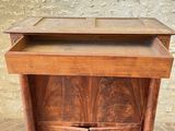 a wooden cabinet with a drawer on top of it