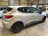 a silver car parked in a garage with other cars in the background