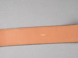 the belt has a gold buckle on it and a brown leather belt with a gold buckle