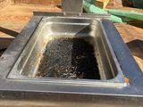 a hot plate that has a lot of black stuff in it