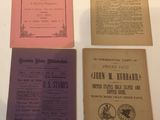 three old books are sitting on a white table