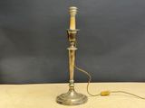 an antique silver plated table lamp with a wooden stick on it