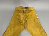 an old pair of yellow pants with gold trims on a white surface