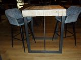 a wooden table with two blue chairs in a restaurant