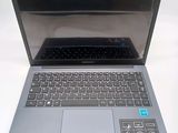 a silver laptop with a black keyboard on a white table