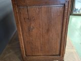 a wooden cabinet with a marble top on a wooden floor
