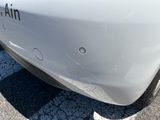 a close up of a white car with a sticker on it
