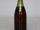 a bottle of wine sitting on a table with a white background