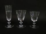 three empty wine glasses sitting next to each other on a black surface