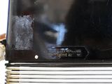 a close up of a black television on a white table