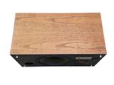 a close up of a wooden box with a speaker on it