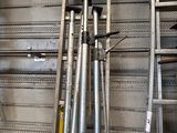 two baseball bats sitting on a rack in a room