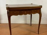 a small wooden table with a marble top on it