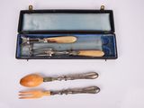 three forks and spoons in a case on a table