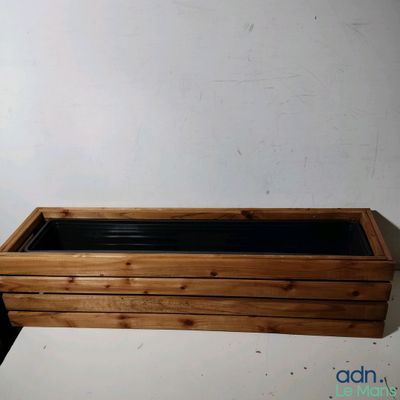 a wooden planter with black liners on it