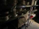 many pots and pans on the shelves in the room