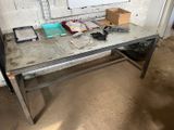 a desk with a glass top and metal legs