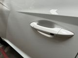 a close up of a door handle on a white car