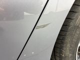 a close up of a car ' s tire on the side of the road
