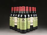 six bottles of red wine lined up in a row on a table