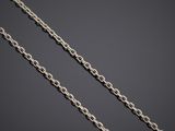 a close up of a silver chain on a black background