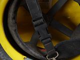 a yellow helmet with a black strap attached to it