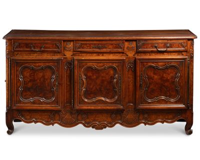 un buffet de style ancien avec des portes et des tiroirs en bois sculpté