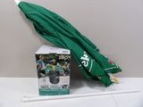 a green umbrella sitting on a table next to a box