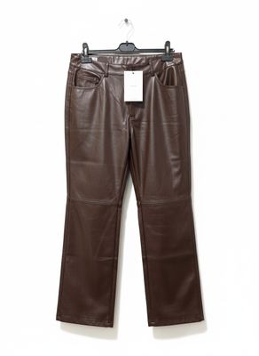 a brown leather pants hanging on a hanger against a white wall